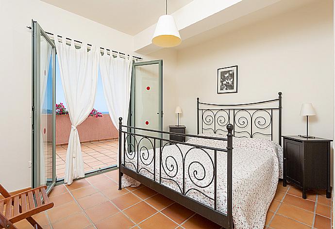 Double bedroom with A/C and deck access . - Villa Vali . (Photo Gallery) }}