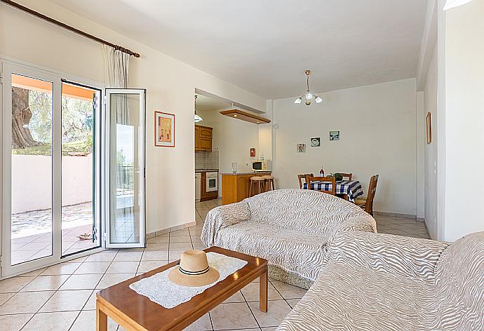 Open-plan living room with sofas, dining area, kitchen WiFi internet, TV, and terrace access . - Villa Youla . (Fotogalerie) }}