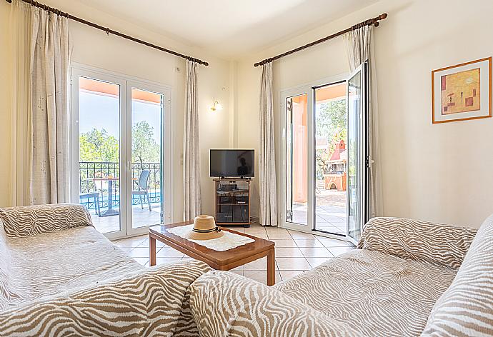 Open-plan living room with sofas, dining area, kitchen WiFi internet, TV, and terrace access . - Villa Youla . (Fotogalerie) }}