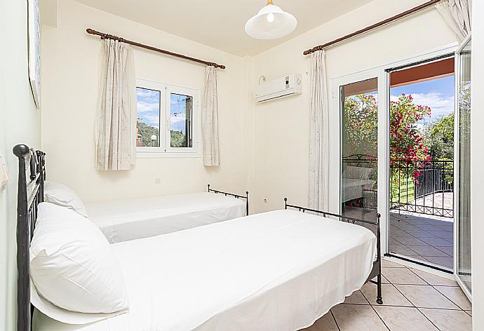 Twin bedroom with A/C and terrace access . - Villa Youla . (Photo Gallery) }}