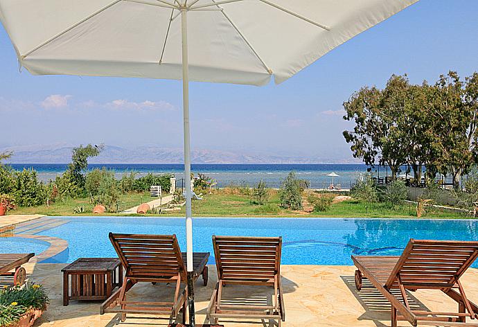 Swimming pool with sea views . - Ormos Beach House . (Photo Gallery) }}