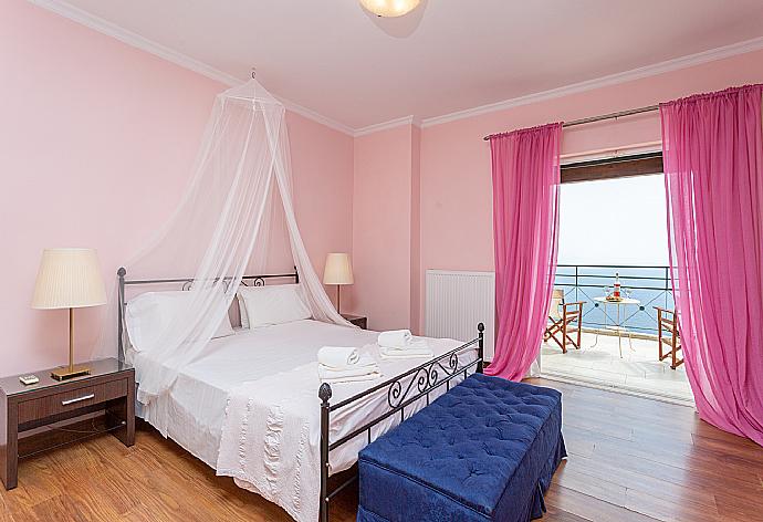 Double bedroom with en suite bathroom, A/C, and balcony access with panoramic sea views . - Villa Georgios . (Photo Gallery) }}