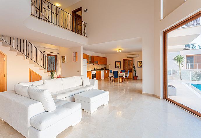 Open-plan living room with sofas, dining area, kitchen, A/C, WiFi internet, satellite TV, DVD player, and terrace access with panoramic sea views . - Villa Lara . (Photo Gallery) }}