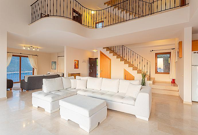 Open-plan living room with sofas, dining area, kitchen, A/C, WiFi internet, satellite TV, DVD player, and terrace access with panoramic sea views . - Villa Lara . (Photo Gallery) }}