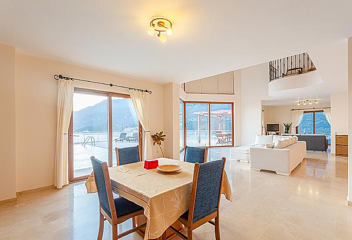 Open-plan living room with sofas, dining area, kitchen, A/C, WiFi internet, satellite TV, DVD player, and terrace access with panoramic sea views . - Villa Lara . (Photo Gallery) }}