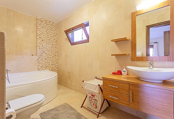 En suite bathroom with spa bath and shower . - Villa Lara . (Photo Gallery) }}