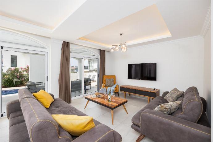 Open-plan living room with sofas, dining area, kitchen, A/C, WiFi internet, and satellite TV . - Orka World Villa 2 . (Photo Gallery) }}