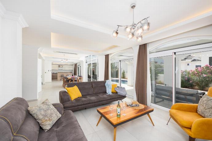 Open-plan living room with sofas, dining area, kitchen, A/C, WiFi internet, and satellite TV . - Orka World Villa 2 . (Photo Gallery) }}