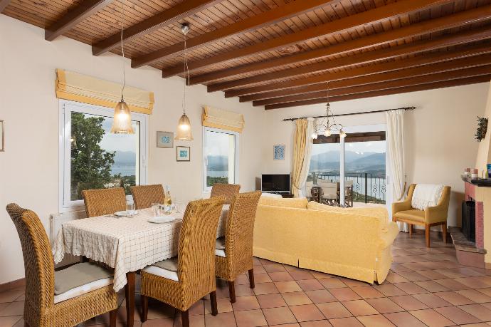 Living room on first floor with sofas, dining area, ornamental fireplace, WiFi internet, satellite TV, and sea views . - Villa Eleni . (Galería de imágenes) }}