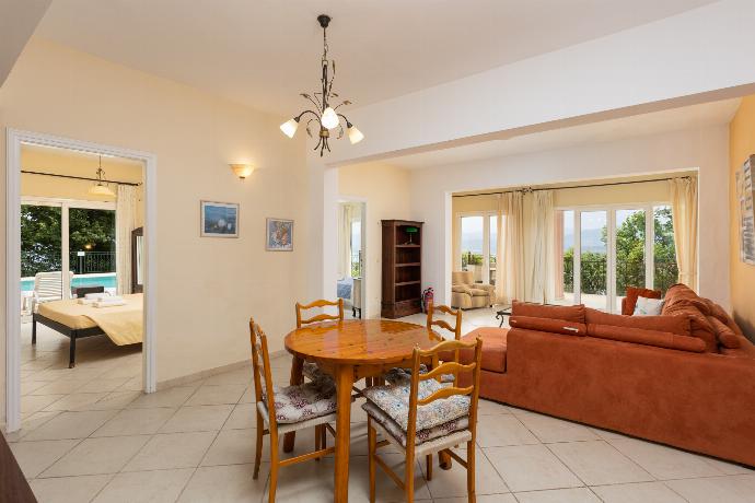 Living room on ground floor with sofa, dining area, and kitchenette . - Villa Eleni . (Galleria fotografica) }}