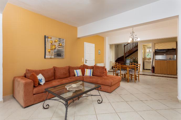 Living room on ground floor with sofa, dining area, and kitchenette . - Villa Eleni . (Galerie de photos) }}