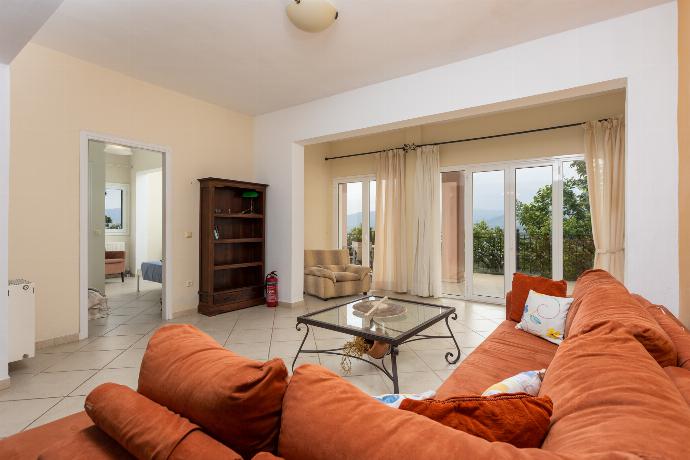 Living room on ground floor with sofa, dining area, and kitchenette . - Villa Eleni . (Galería de imágenes) }}