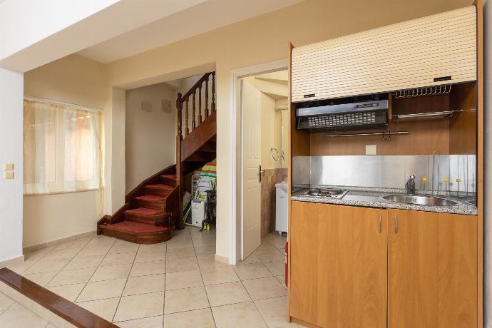 Living room on ground floor with sofa, dining area, and kitchenette . - Villa Eleni . (Galleria fotografica) }}