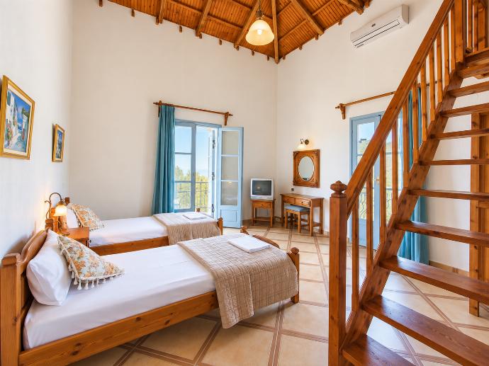 Twin bedroom with A/C, en suite bathroom and terrace access . - Villa Ourania . (Photo Gallery) }}