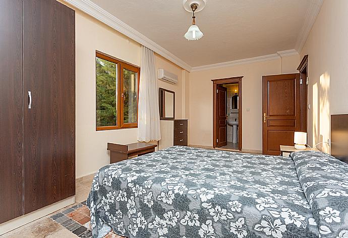 Double bedroom with en suite bathroom, A/C, and balcony access . - Villa Antiphellos . (Photo Gallery) }}