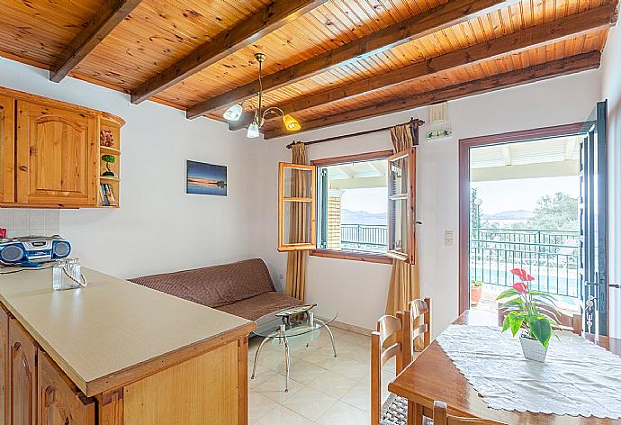 Living room with sofa, dining area, kitchen, and terrace access . - Villa Sofia . (Galería de imágenes) }}