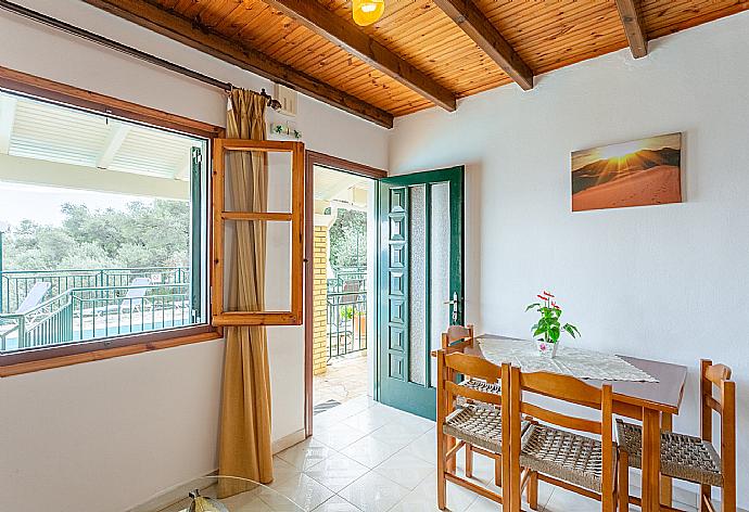 Living room with sofa, dining area, kitchen, and terrace access . - Villa Sofia . (Galerie de photos) }}