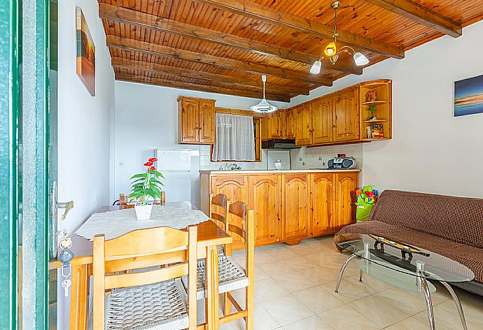 Living room with sofa, dining area, kitchen, and terrace access . - Villa Sofia . (Galerie de photos) }}