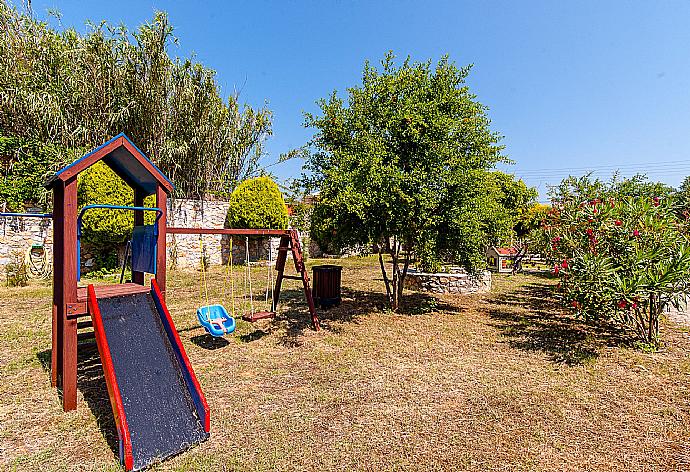 Playground in shared garden area of Eleon Villas . - Villa Melina . (Photo Gallery) }}