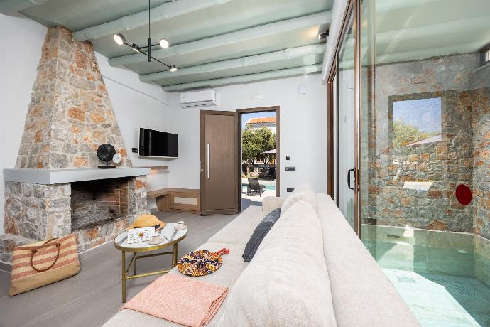 Open-plan living room with sofa, dining area, kitchen, indoor pool, ornamental fireplace, A/C, WiFi internet, and satellite TV . - Villa Nineta . (Photo Gallery) }}