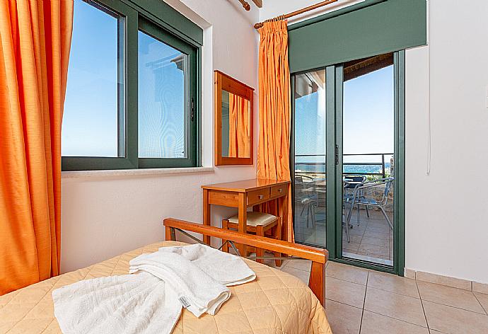 Twin bedroom with A/C and balcony access with sea views . - Andreas Beach Villa . (Photo Gallery) }}