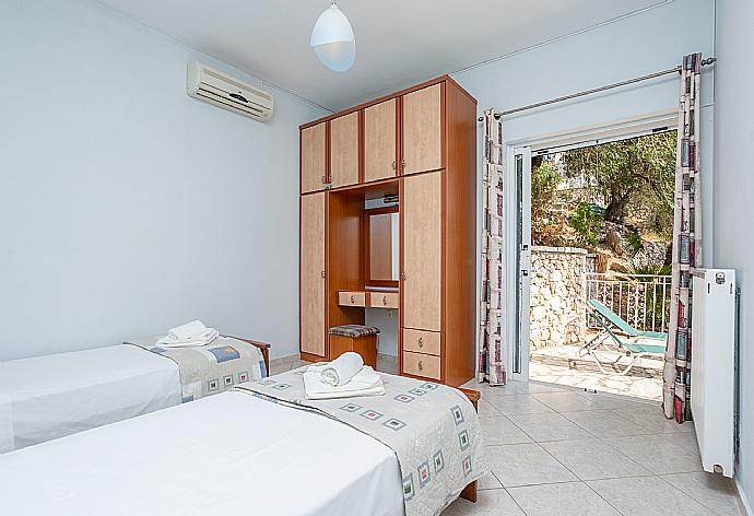 Twin bedroom with A/C and upper terrace access with sea views . - Villa Petros . (Photo Gallery) }}