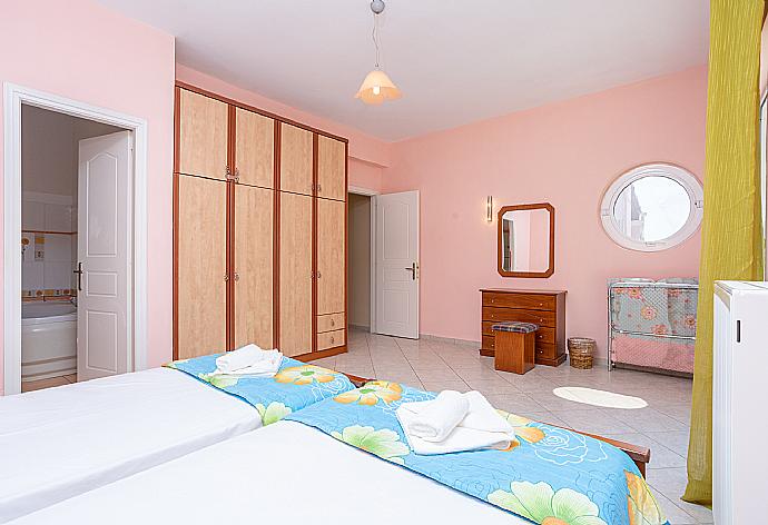 Twin bedroom with en suite bathroom, A/C, and upper terrace access with sea views . - Villa Petros . (Photo Gallery) }}