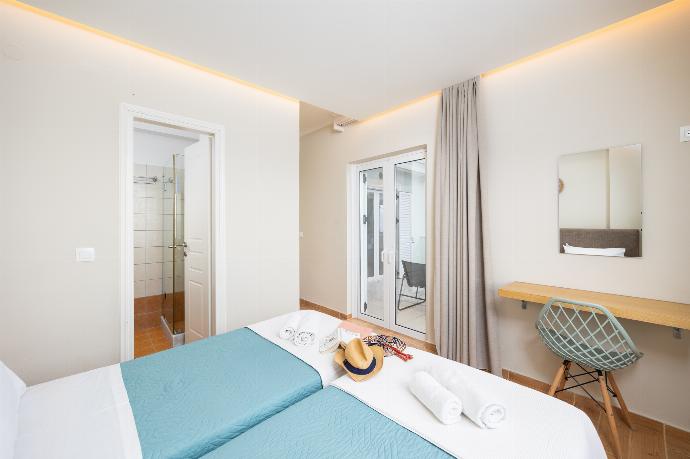 Twin bedroom with en suite bathroom, A/C, and sea views . - Villa Ioanna Agios Stephanos . (Photo Gallery) }}