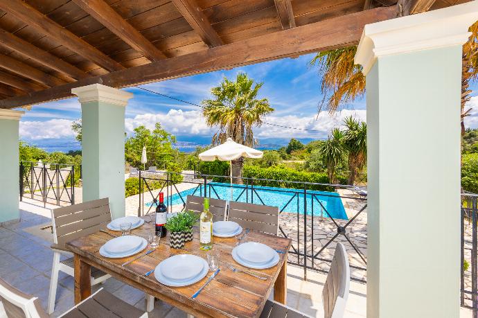 Sheltered terrace area with sea views . - Villa Ioanna Agios Stephanos . (Photo Gallery) }}