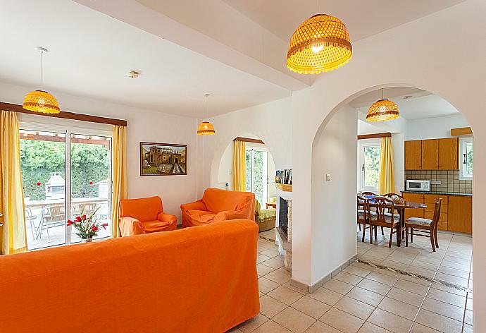 Open-plan living room with sofas, dining area, kitchen, ornamental fireplace, WiFi internet, and satellite TV . - Villa Nansoula . (Photo Gallery) }}