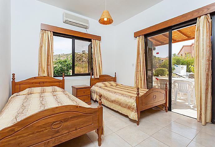 Twin bedroom with A/C and terrace access . - Villa Eleni . (Photo Gallery) }}