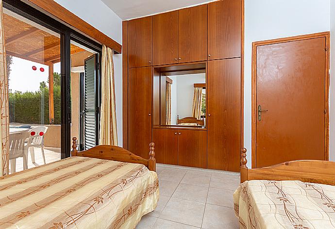 Twin bedroom with A/C and terrace access . - Villa Eleni . (Photo Gallery) }}