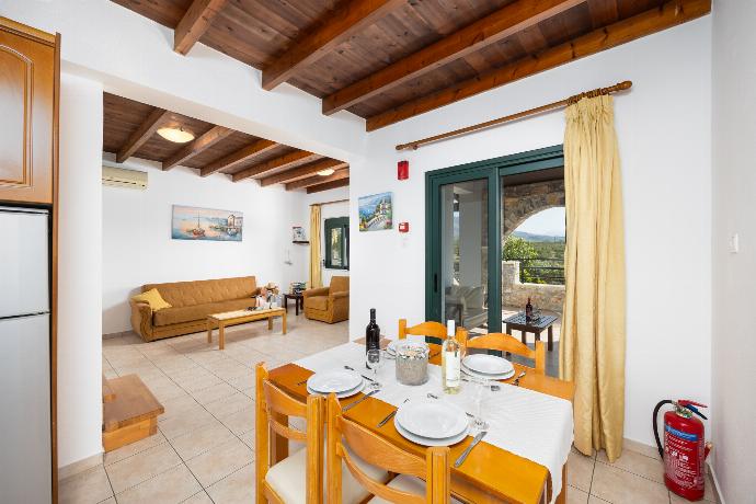 Upper unit: open-plan living room with sofa, dining area, kitchen, A/C, WiFi internet, and satellite TV . - Theo Beach Villa . (Photo Gallery) }}