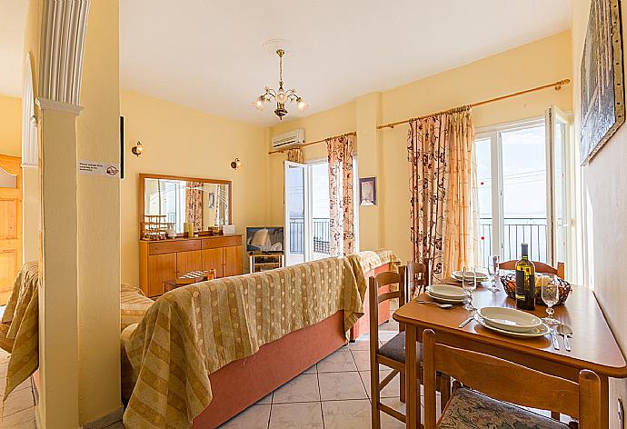 Open-plan living room with WiFi Internet, Satellite TV, DVD player, dining area, equipped kitchen and balcony access . - Villa Ariadni . (Photo Gallery) }}