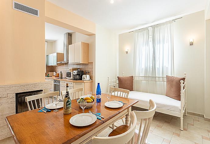 Living area on ground floor with sofa, dining area, kitchen, ornamental fireplace, A/C, and WiFi internet . - Villa Fedra . (Fotogalerie) }}