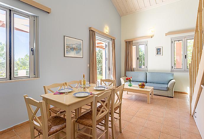 Open-plan living room with sofa, dining area, kitchen, mezzanine, A/C, WiFi internet, satellite TV, and terrace access . - Nafsika Beach House . (Fotogalerie) }}