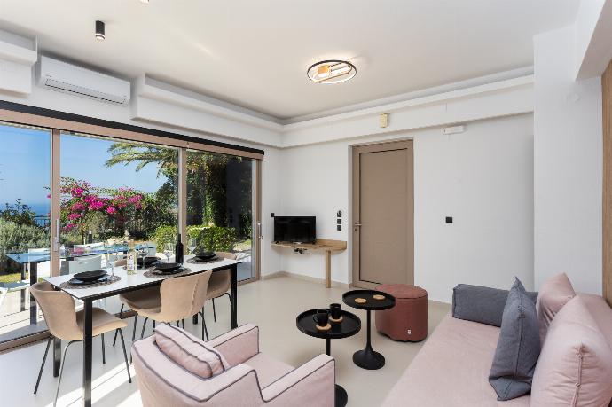 Open-plan living room with sofa, dining area, kitchen, A/C, WiFi internet, satellite TV, and sea views . - Villa Sevos . (Galleria fotografica) }}