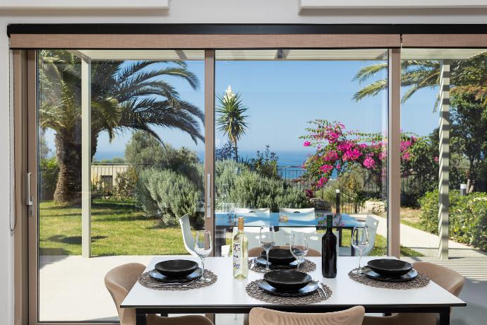 Open-plan living room with sofa, dining area, kitchen, A/C, WiFi internet, satellite TV, and sea views . - Villa Sevos . (Fotogalerie) }}