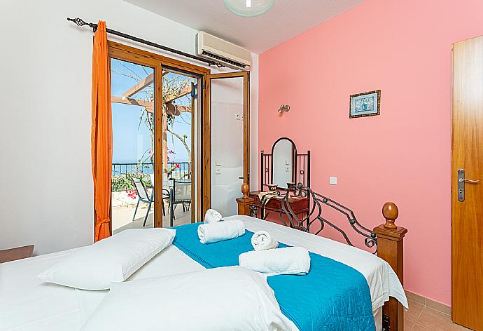 Double bedroom with A/C and balcony access . - Villa Garifallia . (Photo Gallery) }}