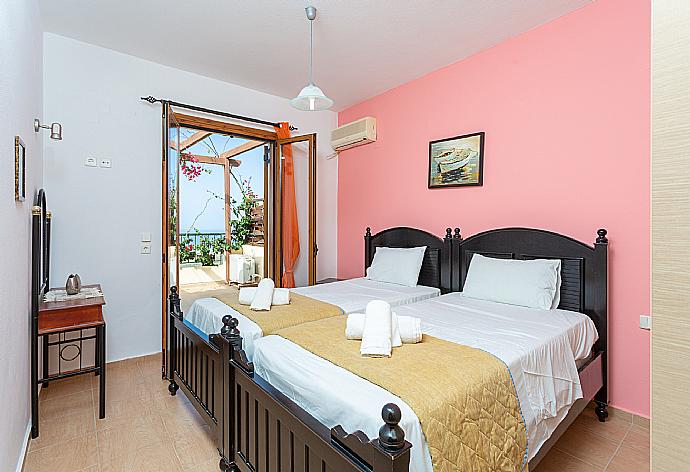 Twin bedroom with A/C and balcony access . - Villa Garifallia . (Photo Gallery) }}