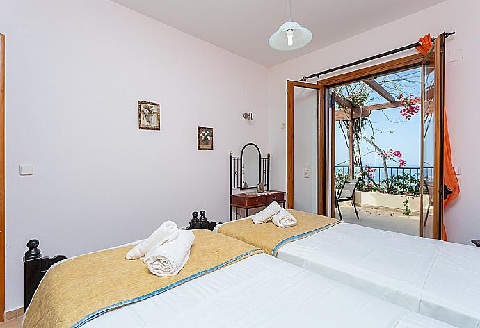 Twin bedroom with A/C and balcony access . - Villa Garifallia . (Photo Gallery) }}