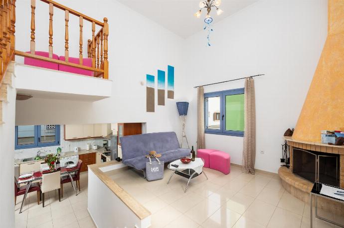 Open-plan living room with sofa, dining area, kitchen, ornamental fireplace, A/C, WiFi internet, and satellite TV . - Villa Nisyros . (Photo Gallery) }}