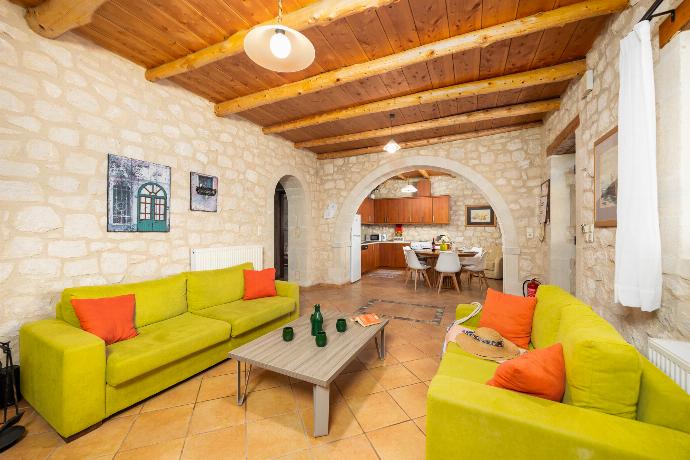 Open-plan living room with sofas, dining area, kitchen, ornamental fireplace, A/C, WiFi internet, and satellite TV . - Villa Hara Faragi . (Галерея фотографий) }}