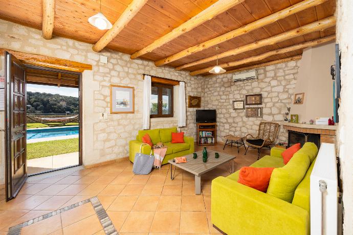 Open-plan living room with sofas, dining area, kitchen, ornamental fireplace, A/C, WiFi internet, and satellite TV . - Villa Hara Faragi . (Галерея фотографий) }}