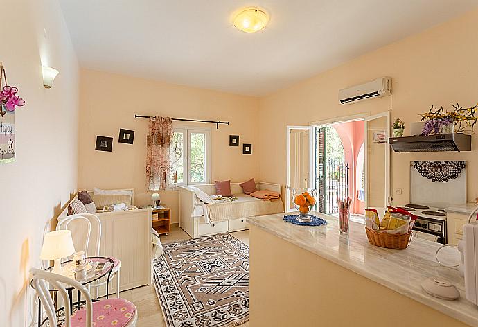 Living area on ground floor with sofa beds, kitchen, A/C, and pool terrace access with sea views . - Bougainvillea . (Fotogalerie) }}