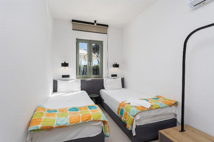 Twin bedroom with en suite bathroom, A/C, and TV . - Villa Michalis . (Photo Gallery) }}