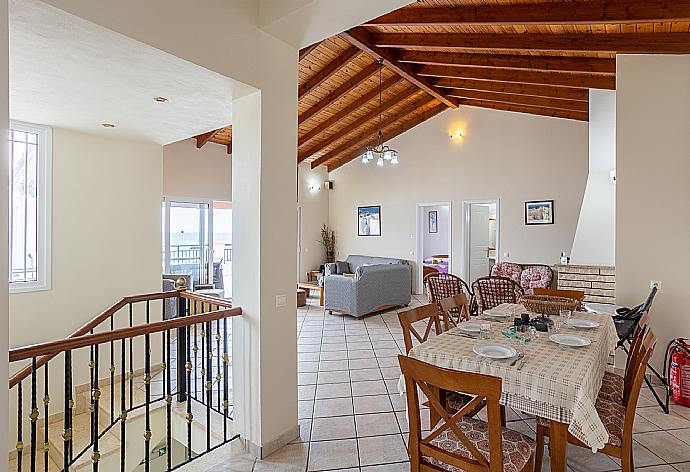 Open-plan living room with sofas, dining area, kitchen, ornamental fireplace, WiFi internet, satellite TV, and sea views . - Villa Kerkyroula . (Galleria fotografica) }}