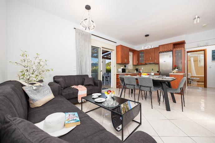 Open-plan living room with sofas, dining area, kitchen, A/C, WiFi internet, and satellite TV . - Villa Georgia . (Photo Gallery) }}