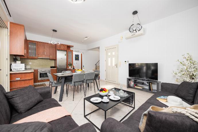 Open-plan living room with sofas, dining area, kitchen, A/C, WiFi internet, and satellite TV . - Villa Georgia . (Photo Gallery) }}