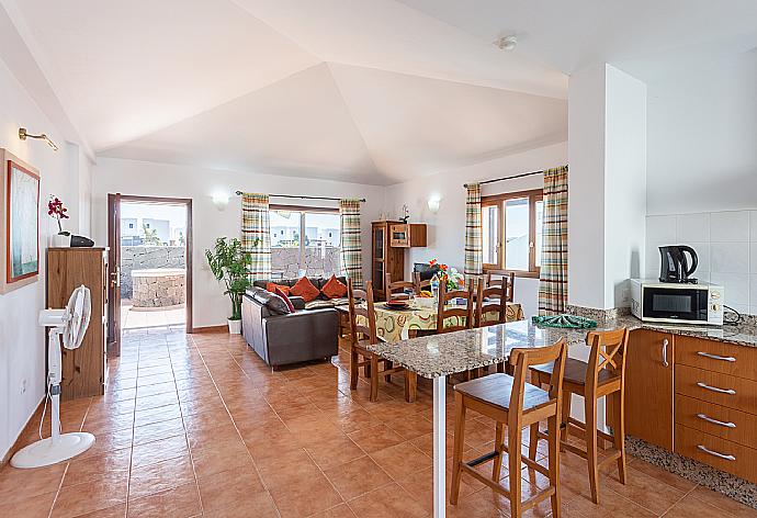 Open-plan living room with sofas, dining area, kitchen, WiFi internet, satellite TV,  DVD player, and terrace access . - Villa Pepe . (Galería de imágenes) }}